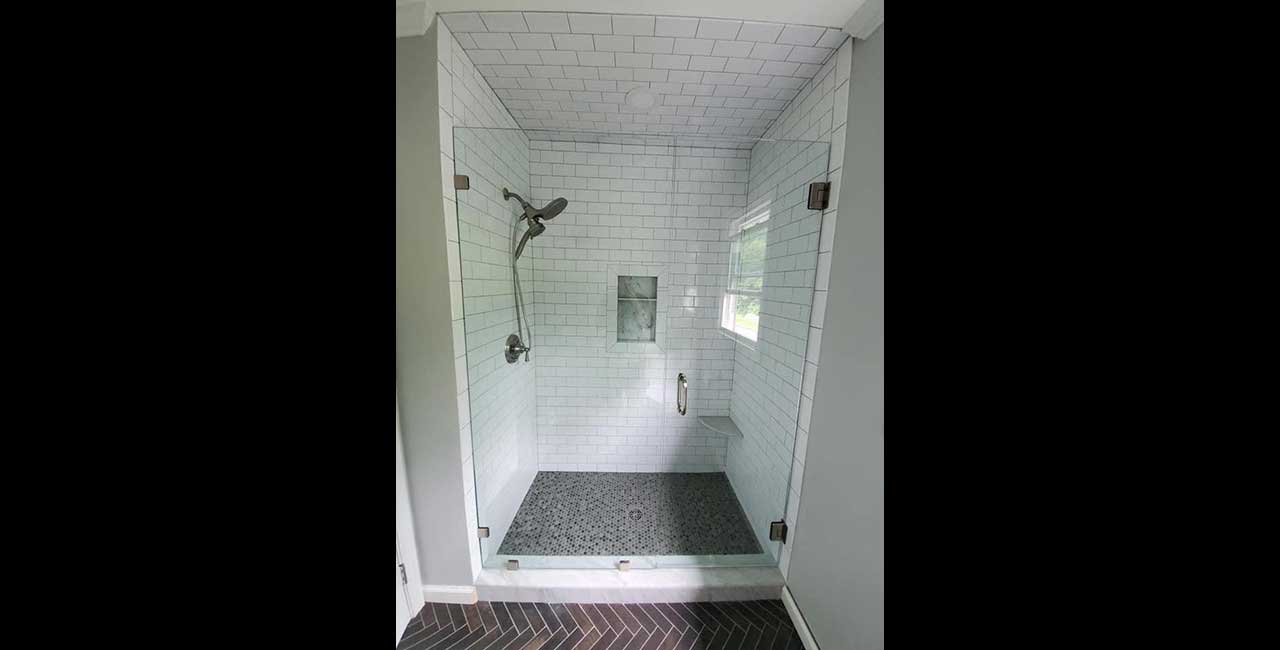 Frameless shower door with a fixed panel